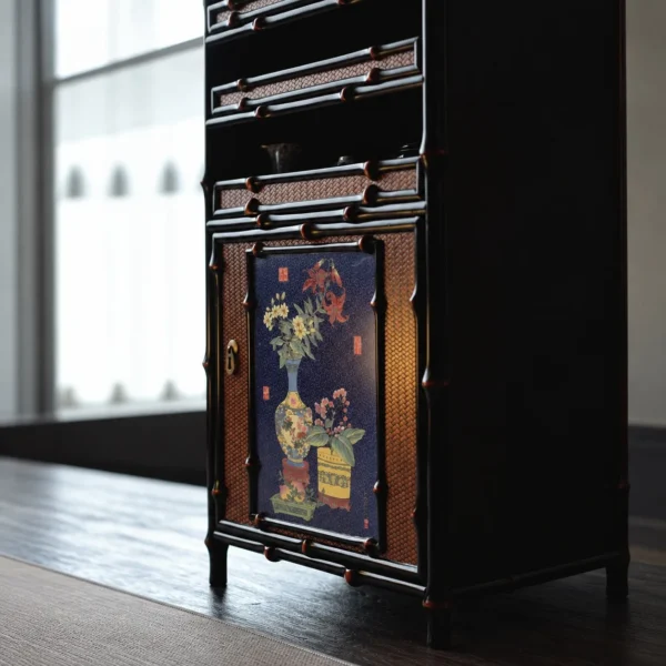 Qingyu Bamboo Apothecary Cabinet with Painted Floral Doors in black — in a room setting