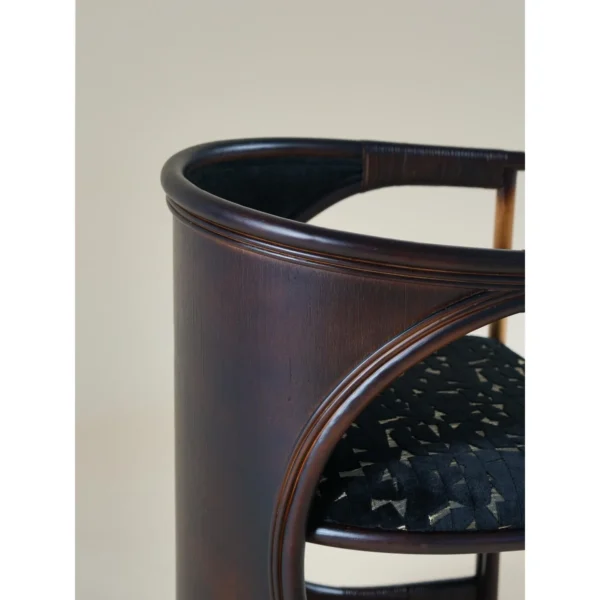 Qionglan Bamboo and Rattan Barrel Chair in black — in a room setting