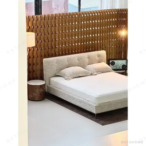 Bouclé Bed with Tufted Headboard on Black Frame in oatmeal — in a room setting