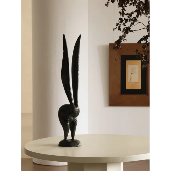 Hand-Carved Wooden Rabbit Sculpture in natural oak — in a room setting