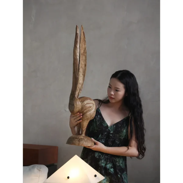 Hand-Carved Wooden Rabbit Sculpture in natural oak — in a room setting