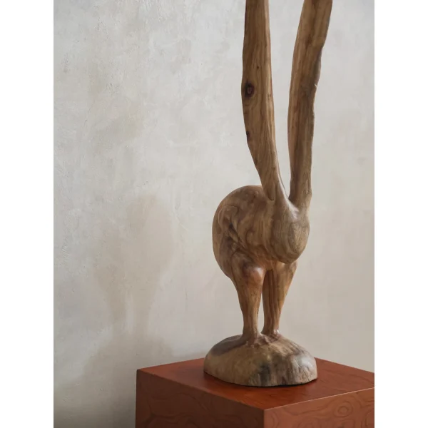 Hand-Carved Wooden Rabbit Sculpture in natural oak — in a room setting