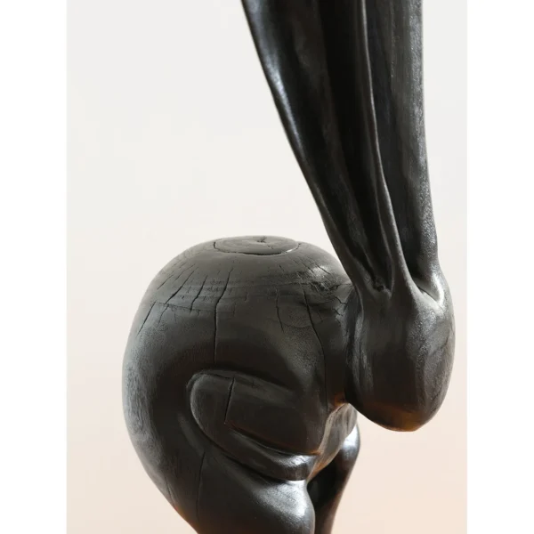 Hand-Carved Wooden Rabbit Sculpture in natural oak — in a room setting
