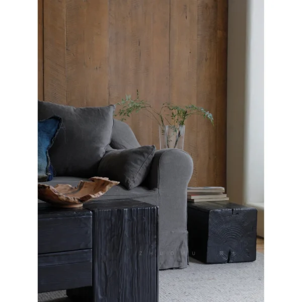 Charred Black Wood Stump Flower Pedestal in black — in a room setting