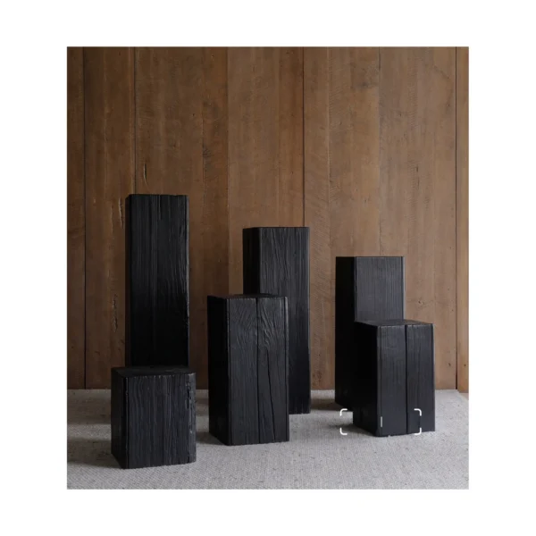 Charred Black Wood Stump Flower Pedestal in black — in a room setting