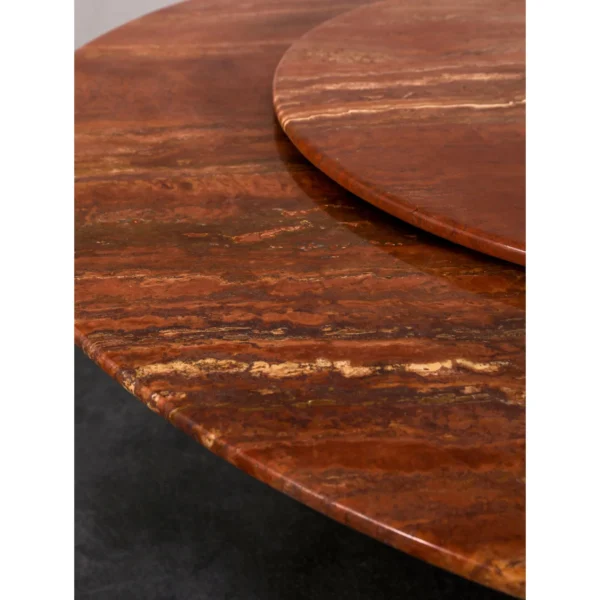 Red Travertine Round Dining Table with Lazy Susan in rust — in a room setting