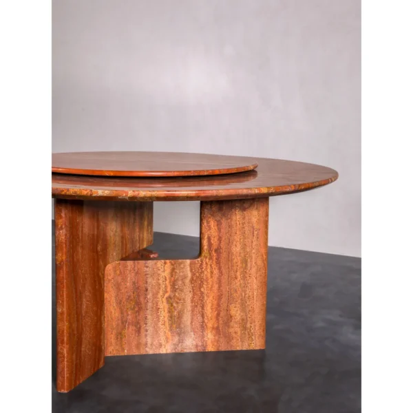 Red Travertine Round Dining Table with Lazy Susan in rust — in a room setting