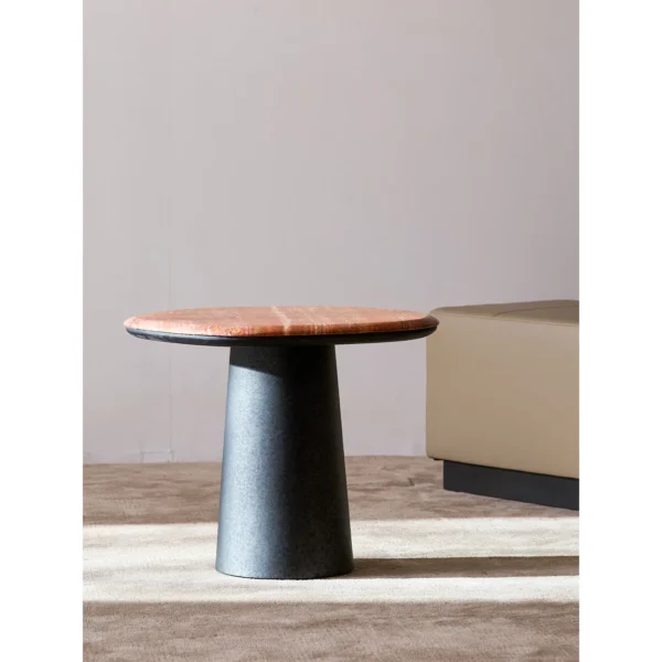 Red Travertine Pebble Side Table on Black Cylinder Base in red — in a room setting