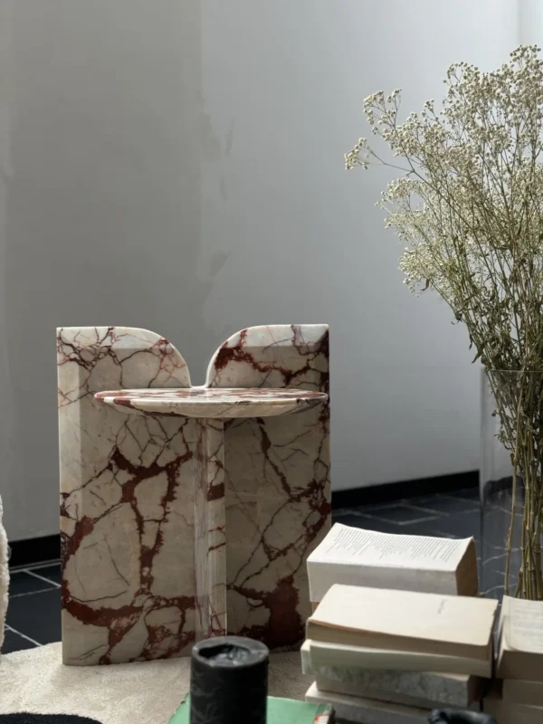 Red Veined Marble Geometric Side Table with Round Top in red — in a room setting
