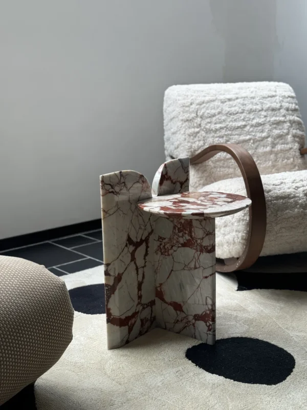 Red Veined Marble Geometric Side Table with Round Top in red — in a room setting