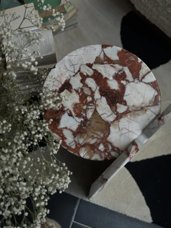 Red Veined Marble Geometric Side Table with Round Top in red — in a room setting