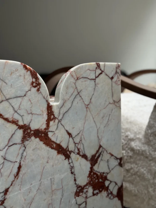 Red Veined Marble Geometric Side Table with Round Top in red — in a room setting