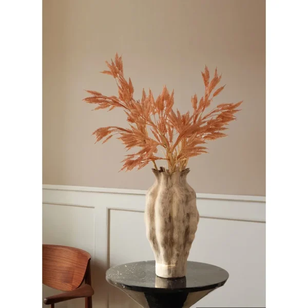 Reed Grass Artificial Stems in clay — in a room setting