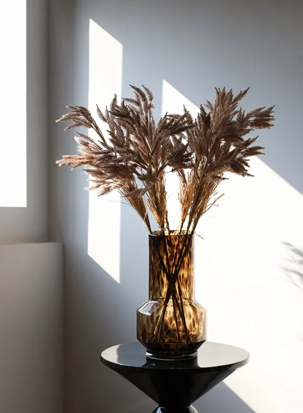 Reed Grass Artificial Stems in clay — in a room setting