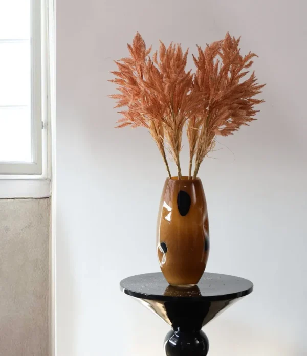 Reed Grass Artificial Stems in clay — in a room setting