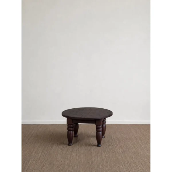 Remain Round Solid Wood Coffee Table on Turned Legs in clay — in a room setting