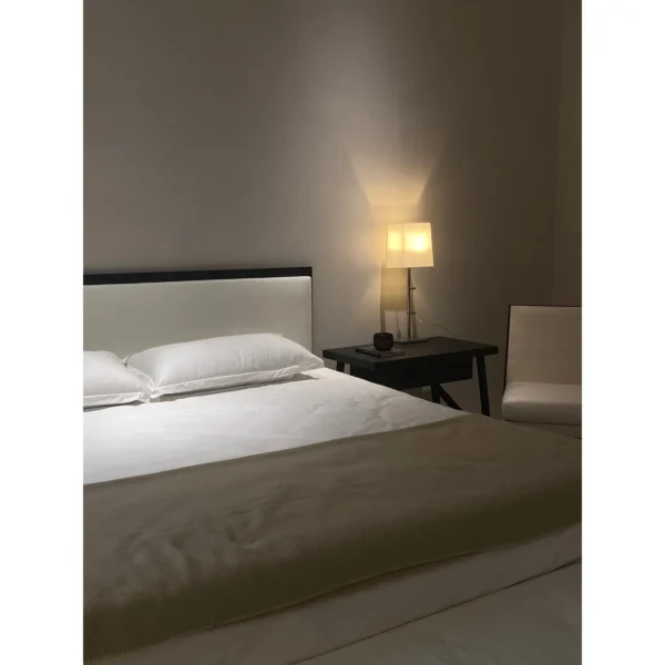 Restrained Oak-Framed Leather Bed in White — in a room setting