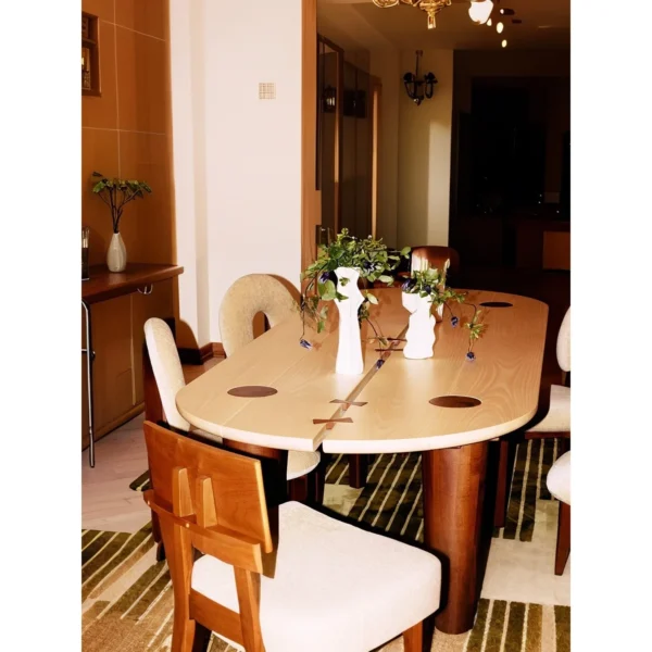 Rhye Oak Oval Dining Table with Inlaid Leg Joints in natural oak — in a room setting