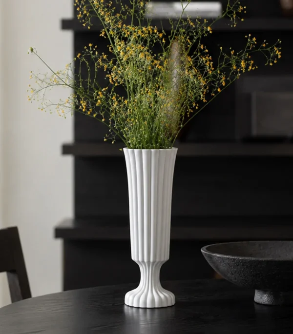 Hand-Made Ribbed Matte White Flared Ceramic Vase in ivory — in a room setting