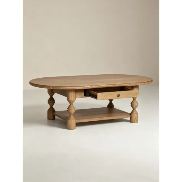 Ridge Carved Oval Ash Coffee Table with Drawer and Shelf in natural oak — in a room setting