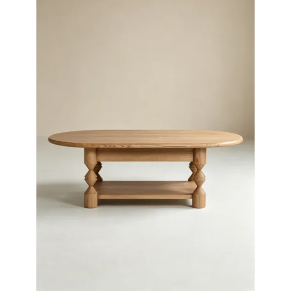 Ridge Carved Oval Ash Coffee Table with Drawer and Shelf in natural oak — in a room setting