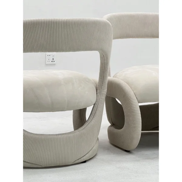 Ring-Frame Pleated Corduroy and Suede Lounge Chair in Black — in a room setting