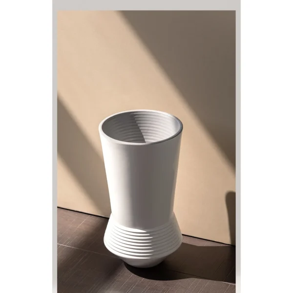 Ring-Stacked Waisted White Ceramic Vase in ivory — in a room setting
