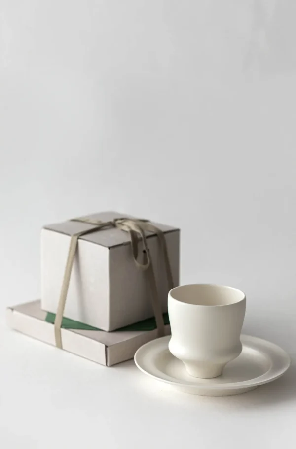 Artist Collaboration White Porcelain Cup and Saucer Gift Set in ivory — in a room setting