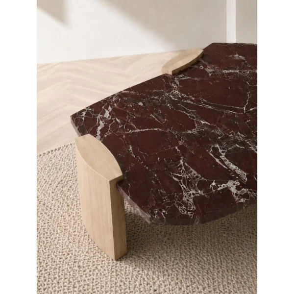 Rosso Levanto Marble Coffee Table on Light Wood Legs in burgundy — in a room setting