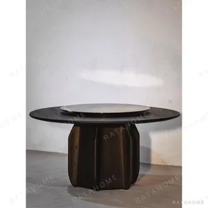 Dark Solid Wood Round Dining Table in black — in a room setting