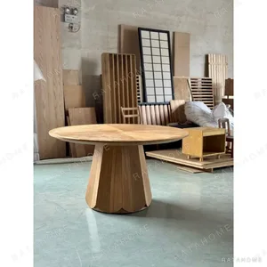 Textured White Oak Round Dining Table on Faceted Pedestal in natural oak — in a room setting