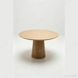 White Oak Round Dining Table on Faceted Cone Pedestal in natural oak — in a room setting
