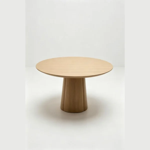 White Oak Round Dining Table on Faceted Cone Pedestal in natural oak — in a room setting