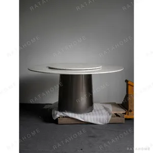 White Marble Round Table with Lazy Susan on Dark Cone Base in ivory — in a room setting