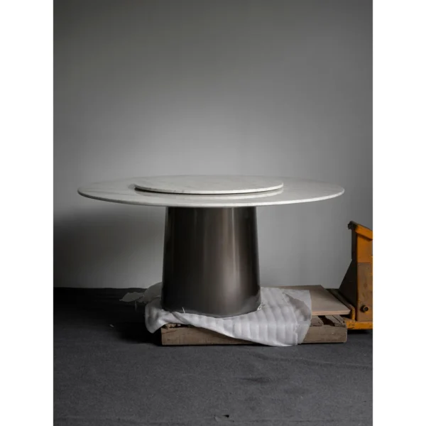 White Marble Round Table with Lazy Susan on Dark Cone Base in ivory — in a room setting