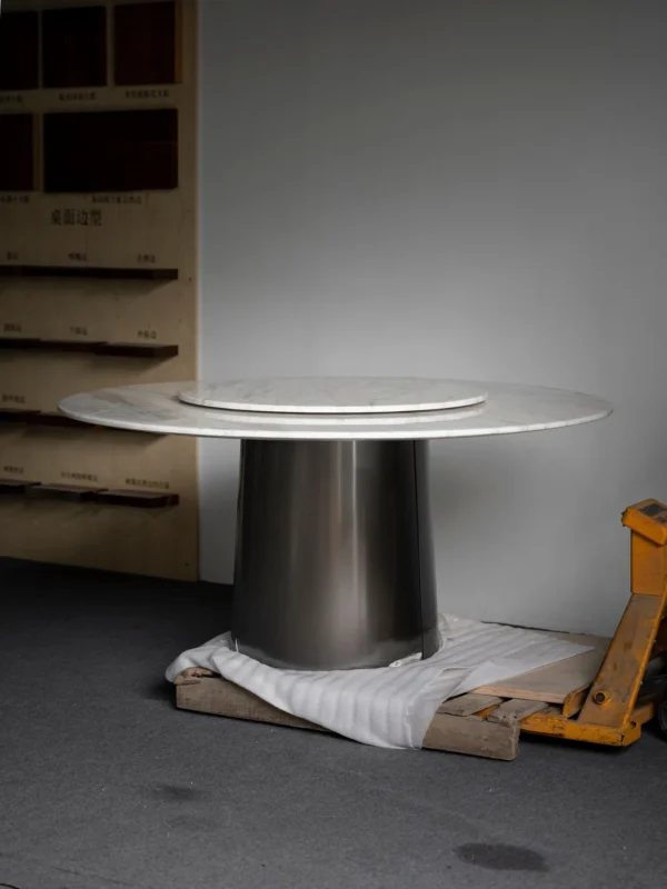 White Marble Round Table with Lazy Susan on Dark Cone Base in ivory — in a room setting