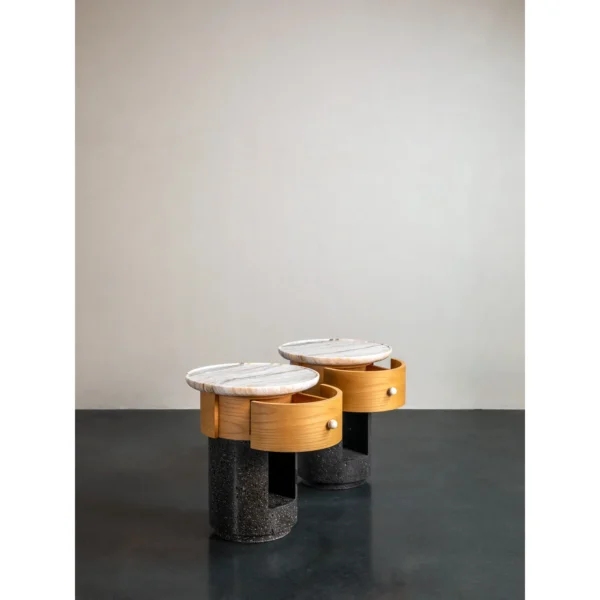 Round Stone Side Table Pair on Wood and Black Stone Bases in oatmeal — in a room setting