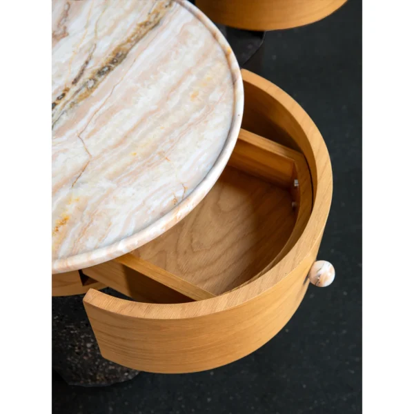 Round Stone Side Table Pair on Wood and Black Stone Bases in oatmeal — in a room setting