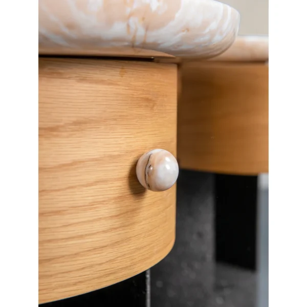 Round Stone Side Table Pair on Wood and Black Stone Bases in oatmeal — in a room setting