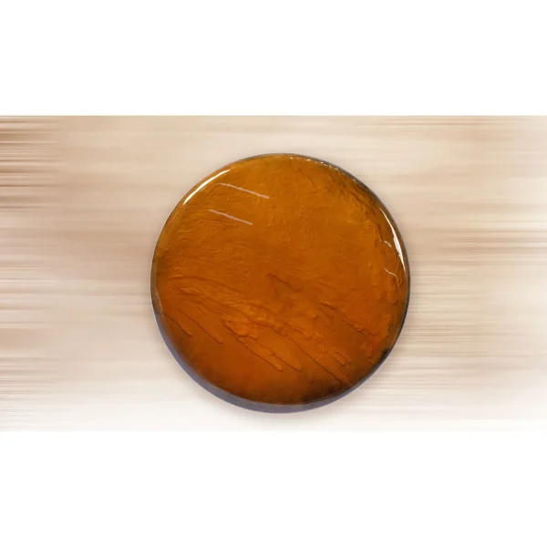 Round Amber Glass Disc Wall Art, 80 cm in rust — in a room setting