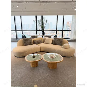 Rounded Curved Sofa in Cream Cotton Linen with Calliper Arm — in a room setting