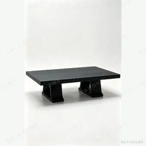 Saddle Black Oak Coffee Table on Slab Legs, 135 x 90 cm in black — in a room setting