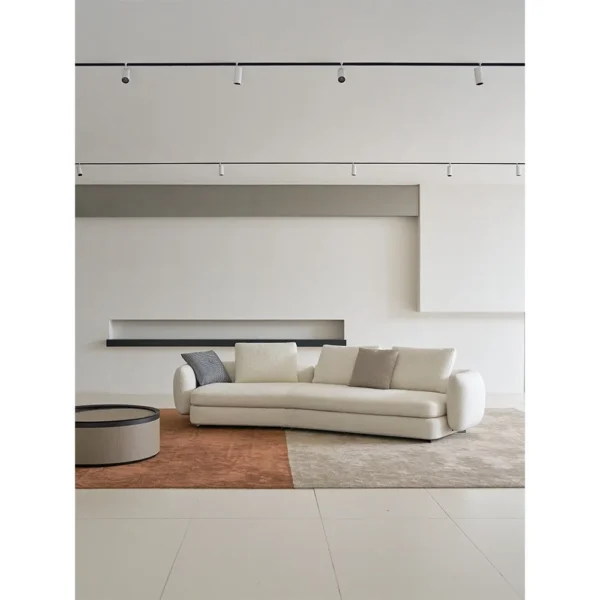 Ring-Arm Curved Sofa in Cream Fabric with Ring Detail — in a room setting