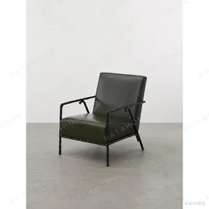 Hand-Forged Iron Lounge Chair in Olive Leather — in a room setting