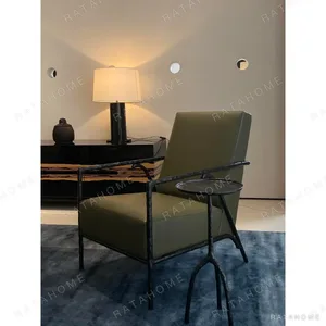 Forged Bronze Armchair in Olive Leather, 65 cm — in a room setting