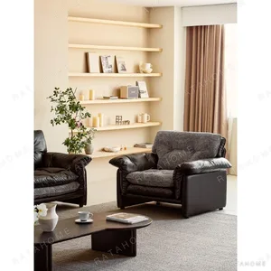 Sandwich Single-Seat Sofa in Black Leather and Grey Bouclé — in a room setting