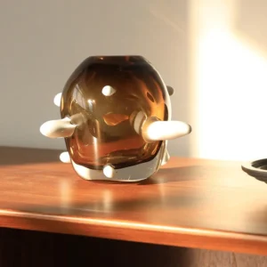Sculptural Amber Glass Vase with Pale Studs in clay — front view