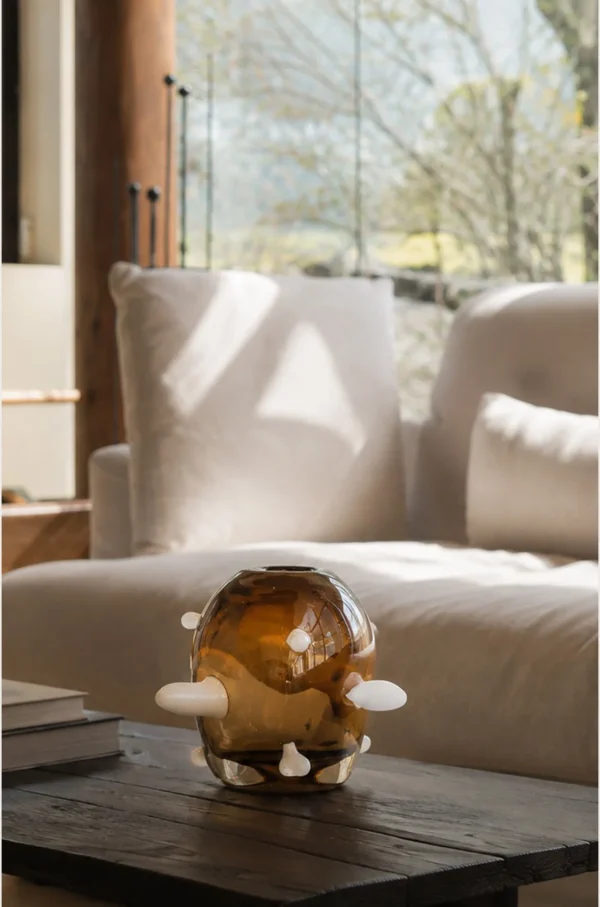 Sculptural Amber Glass Vase with Pale Studs in clay — in a room setting