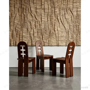 Round Oak Dining Table on Perforated Sculptural Base in natural oak — in a room setting