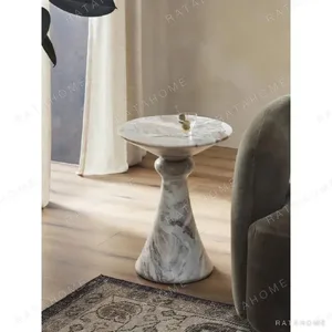 Sculptural Grey Marble Side Table with Fluted Cone Base in ivory — in a room setting